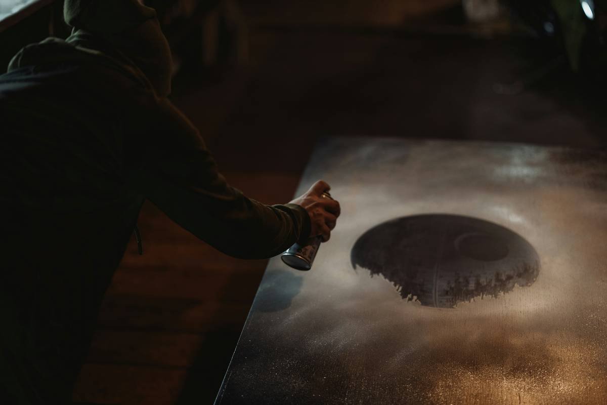 Woman applying makeup smudge proof spray with correct X-and-T misting technique
